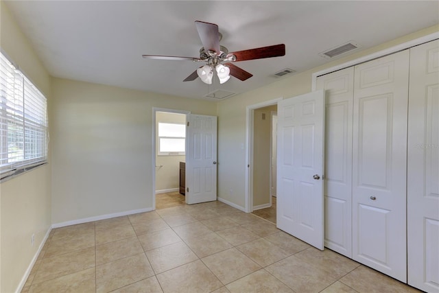 1400 63rd Ave S, Saint Petersburg, FL 33705 - unfurnished bedroom featuring a closet, baseboards, light tile patterned flooring, and a ceiling fan