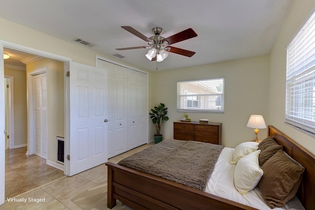 1400 63rd Ave S, Saint Petersburg, FL 33705 - bedroom with light tile patterned floors, a closet, ceiling fan, and ornamental molding