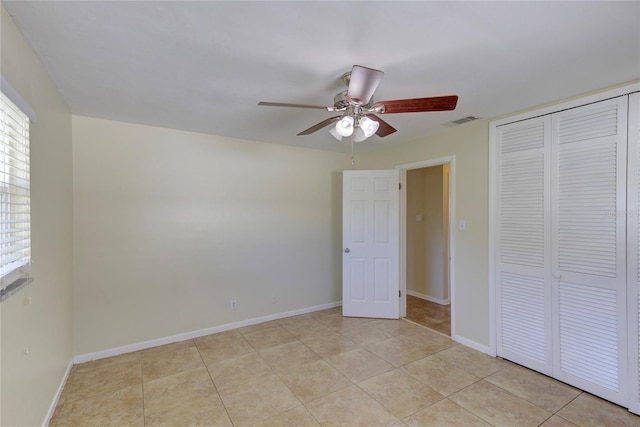 1400 63rd Ave S, Saint Petersburg, FL 33705 - unfurnished bedroom featuring a closet, light tile patterned floors, and baseboards