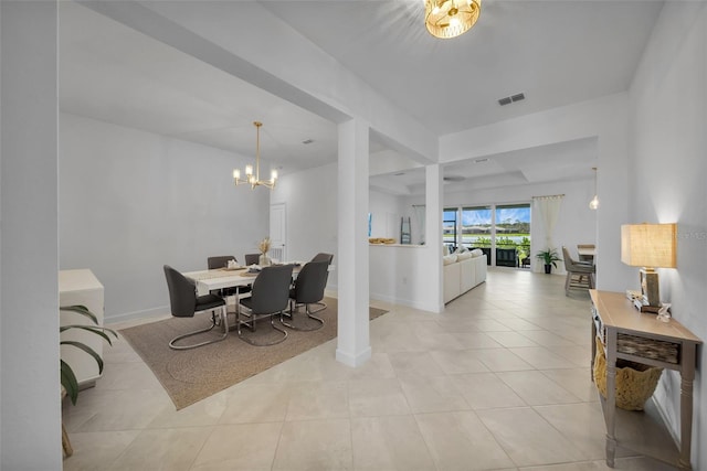 8589 Saint Kitts Cir, Englewood, FL 34224 - dining space with a chandelier, light tile patterned flooring, and baseboards