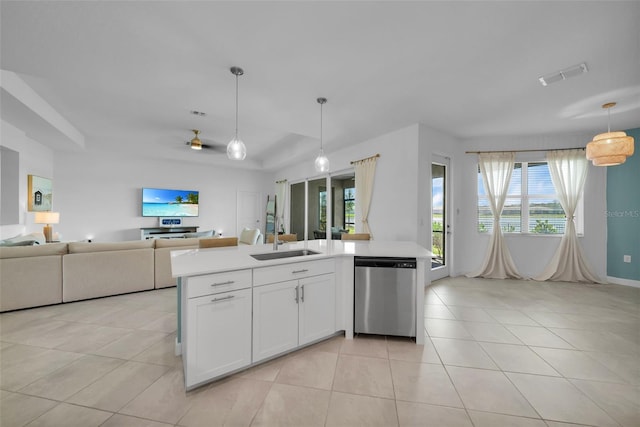 8589 Saint Kitts Cir, Englewood, FL 34224 - kitchen featuring dishwasher, a sink, open floor plan, light tile patterned flooring, and light countertops