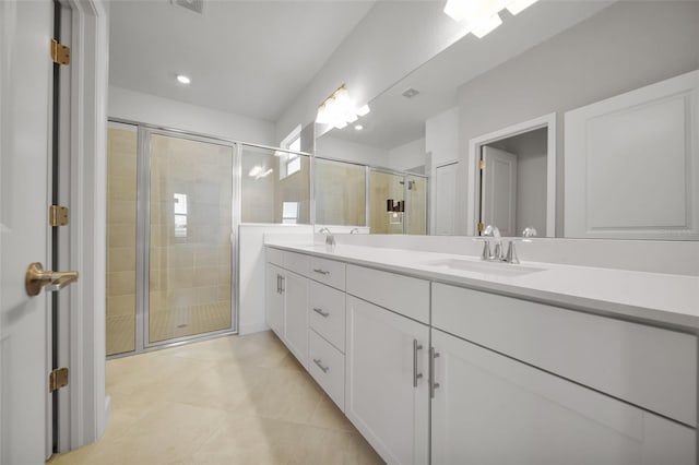 8589 Saint Kitts Cir, Englewood, FL 34224 - bathroom featuring a stall shower, double vanity, tile patterned flooring, and recessed lighting