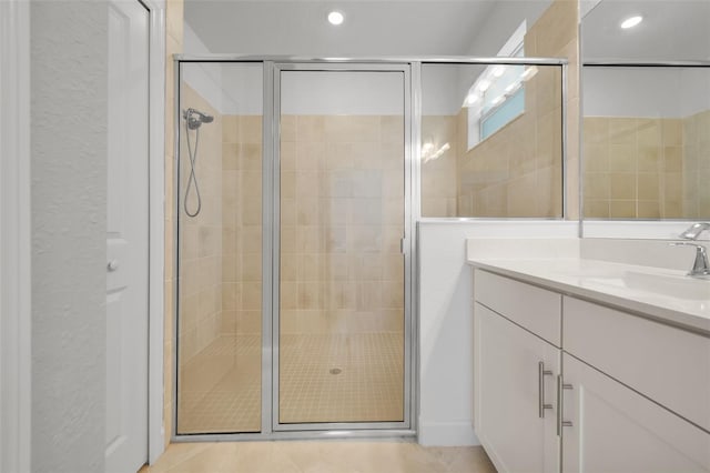 8589 Saint Kitts Cir, Englewood, FL 34224 - bathroom with a shower stall, vanity, tile patterned floors, and recessed lighting