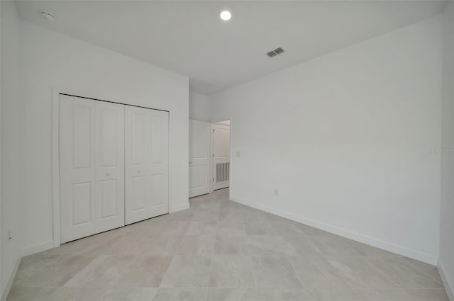 8589 Saint Kitts Cir, Englewood, FL 34224 - unfurnished bedroom with baseboards, recessed lighting, and a closet