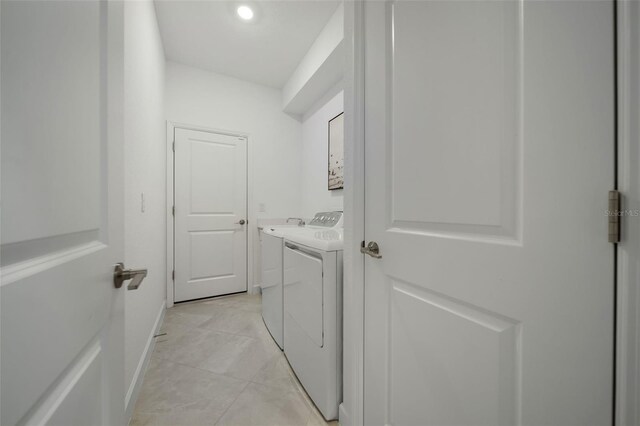 8589 Saint Kitts Cir, Englewood, FL 34224 - laundry room with separate washer and dryer, baseboards, and cabinet space