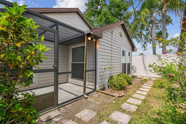 7035 Drury St, Tampa, FL 33635 - view of side of home featuring a patio and fence
