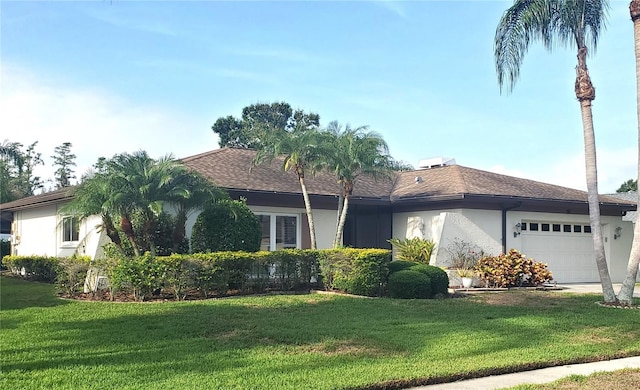 50 Water Oak Way, Oldsmar, FL 34677 - single story home with stucco siding, an attached garage, and a front yard