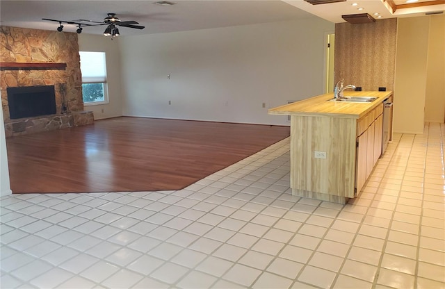 50 Water Oak Way, Oldsmar, FL 34677 - kitchen with light wood-style flooring, track lighting, a sink, a fireplace, and ceiling fan