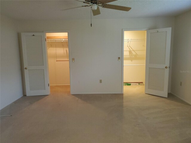 50 Water Oak Way, Oldsmar, FL 34677 - unfurnished bedroom featuring a spacious closet, carpet, a closet, and ceiling fan
