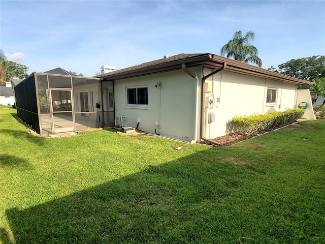 50 Water Oak Way, Oldsmar, FL 34677 - rear view of property with a lawn, stucco siding, and a lanai