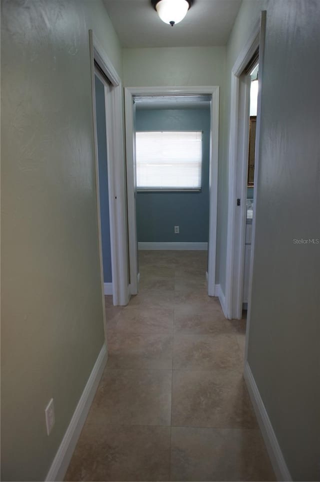 hall featuring baseboards
