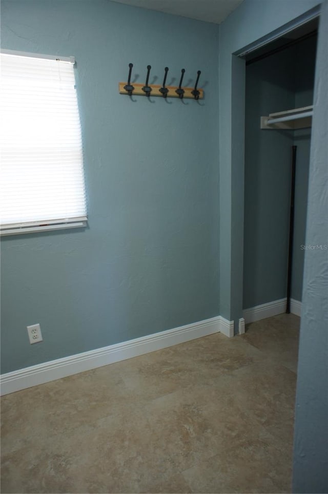 unfurnished dining area with baseboards