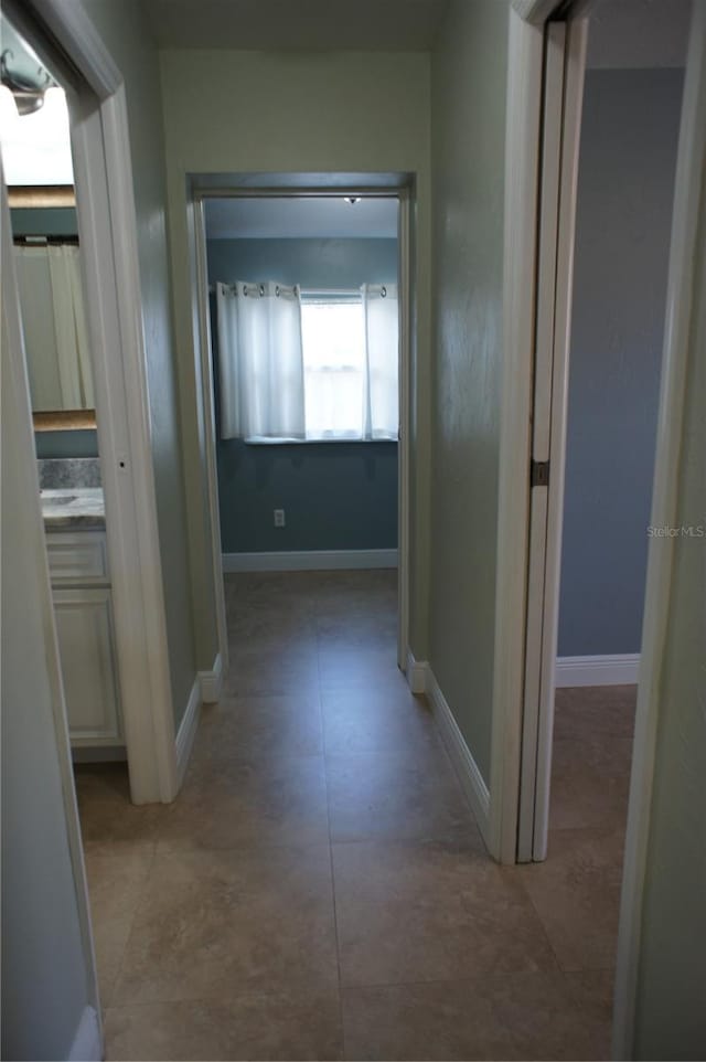 hall featuring baseboards