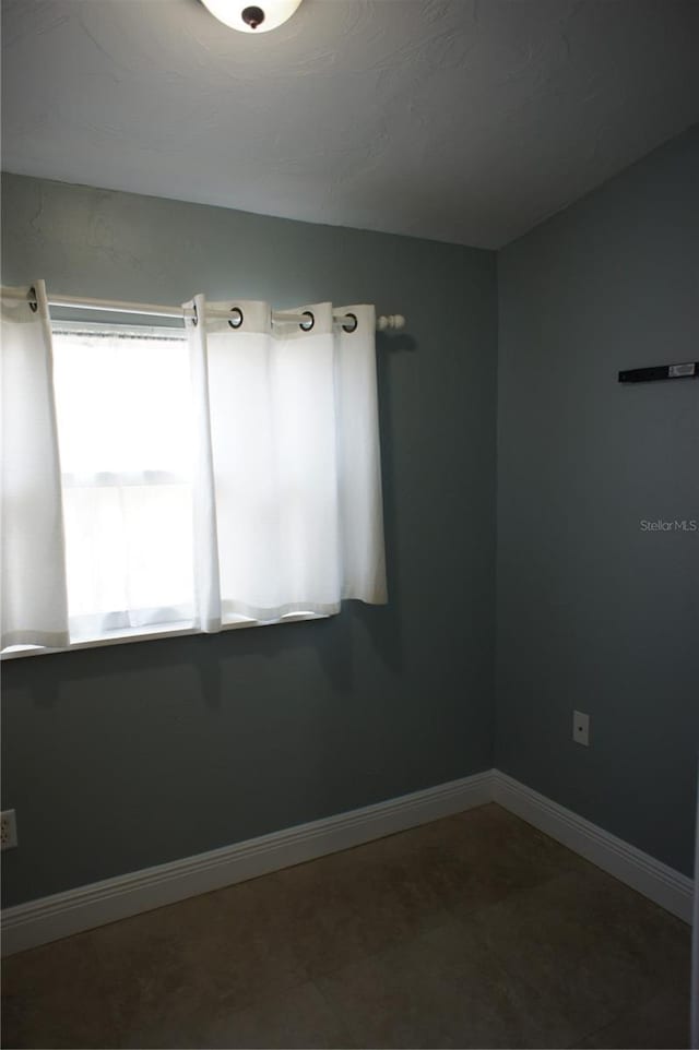 empty room featuring baseboards