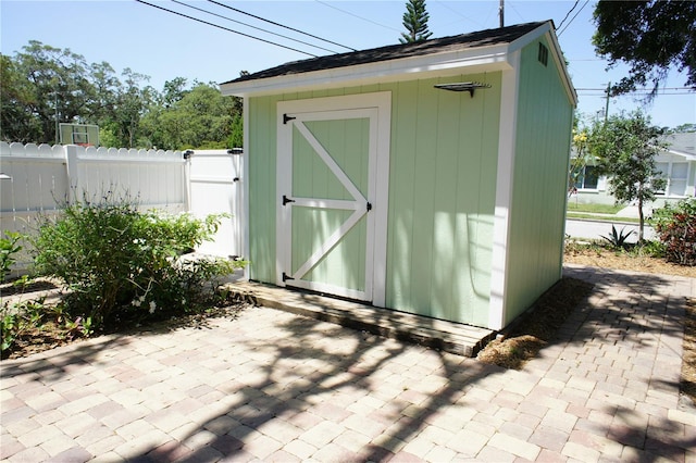 view of shed with fence