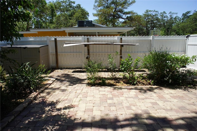 view of patio with a fenced backyard and central air condition unit