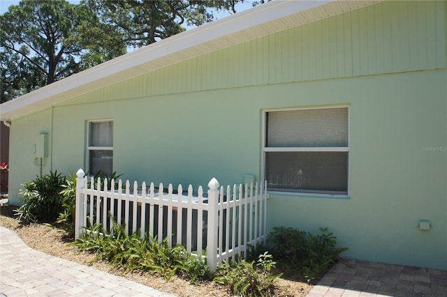 view of home's exterior featuring fence and stucco siding