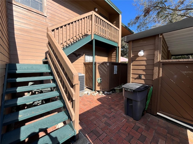 2406 Cypress Pond Rd Unit 2406, Palm Harbor, FL 34683 - view of patio featuring stairway, fence, a balcony, and central air condition unit
