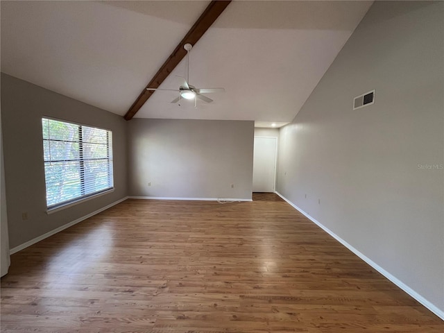 2406 Cypress Pond Rd Unit 2406, Palm Harbor, FL 34683 - spare room featuring a ceiling fan, beam ceiling, wood finished floors, baseboards, and high vaulted ceiling