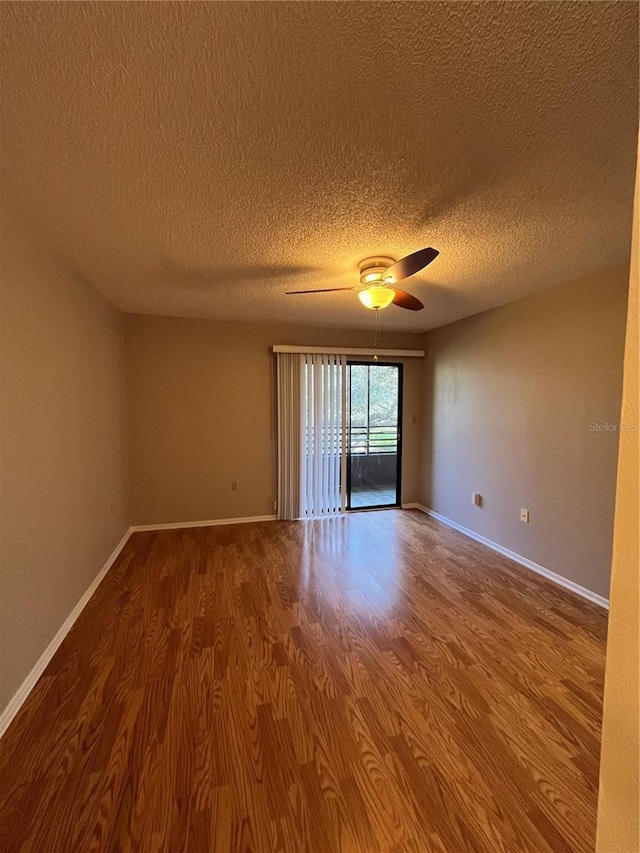 2406 Cypress Pond Rd Unit 2406, Palm Harbor, FL 34683 - unfurnished room with wood finished floors, a ceiling fan, a textured ceiling, and baseboards