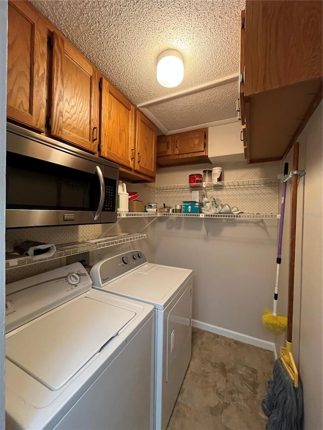 2406 Cypress Pond Rd Unit 2406, Palm Harbor, FL 34683 - laundry room with cabinet space, washing machine and clothes dryer, and a textured ceiling