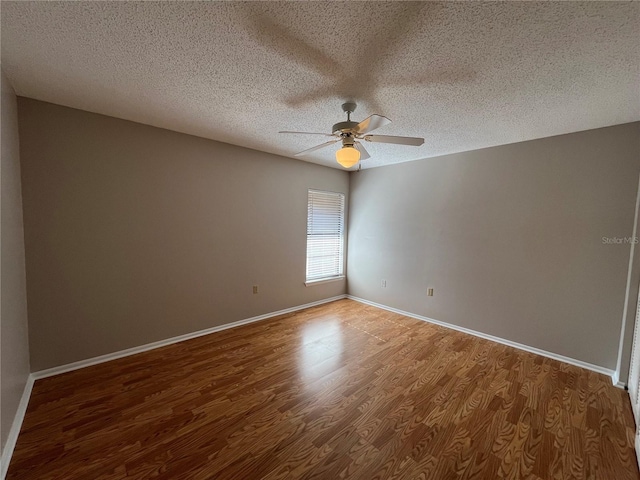 2406 Cypress Pond Rd Unit 2406, Palm Harbor, FL 34683 - spare room with a ceiling fan, a textured ceiling, wood finished floors, and baseboards