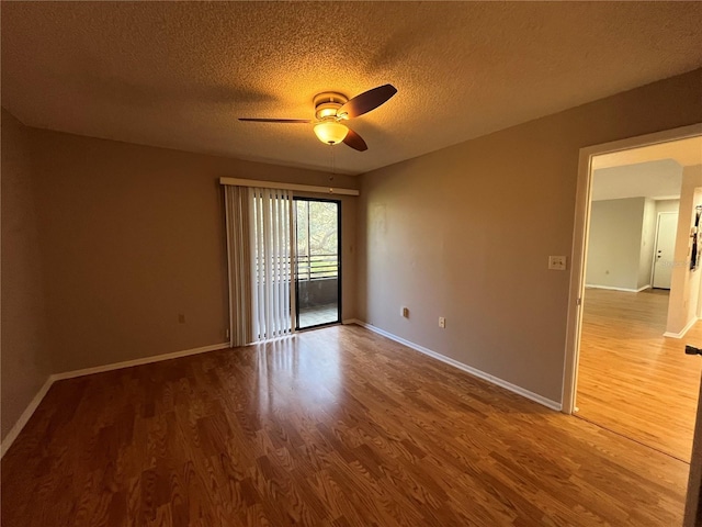 2406 Cypress Pond Rd Unit 2406, Palm Harbor, FL 34683 - empty room featuring a ceiling fan, wood finished floors, a textured ceiling, and baseboards