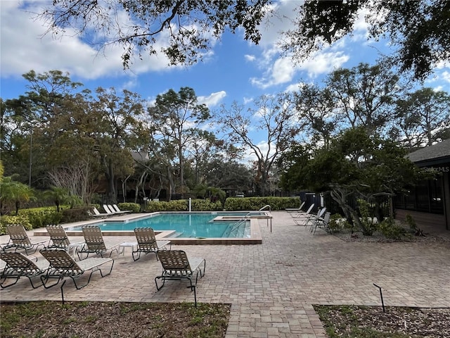 2406 Cypress Pond Rd Unit 2406, Palm Harbor, FL 34683 - community pool featuring a patio