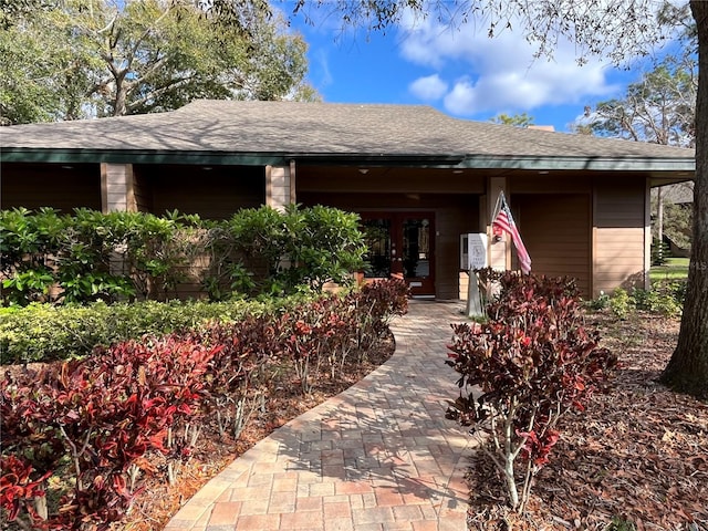 2406 Cypress Pond Rd Unit 2406, Palm Harbor, FL 34683 - property entrance featuring roof with shingles and french doors