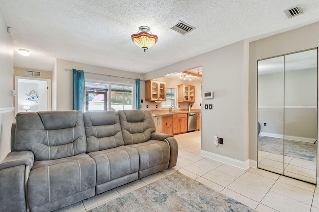 living room with light tile patterned floors and a textured ceiling
