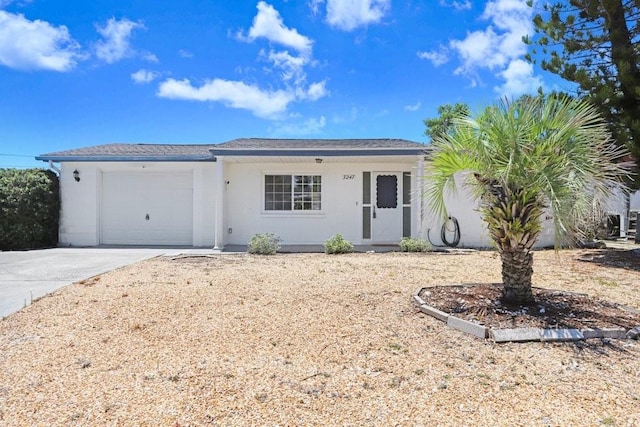 3247 Kimberly Oaks Dr, Holiday, FL 34691 - ranch-style home featuring concrete driveway, an attached garage, and stucco siding