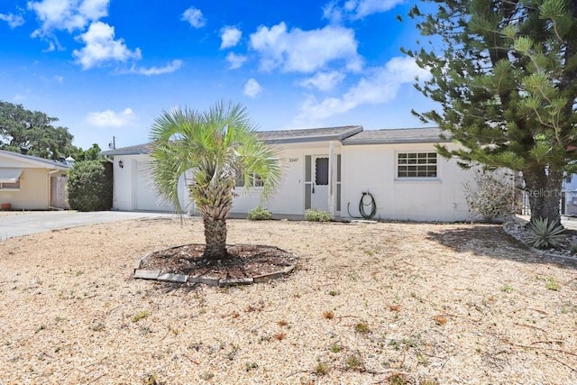 3247 Kimberly Oaks Dr, Holiday, FL 34691 - ranch-style house featuring concrete driveway, a garage, and stucco siding