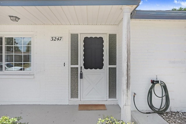 3247 Kimberly Oaks Dr, Holiday, FL 34691 - doorway to property featuring brick siding