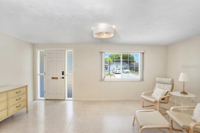 3247 Kimberly Oaks Dr, Holiday, FL 34691 - sitting room with baseboards and speckled floor
