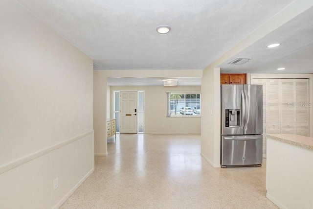 3247 Kimberly Oaks Dr, Holiday, FL 34691 - kitchen featuring stainless steel refrigerator with ice dispenser, baseboards, recessed lighting, brown cabinets, and light countertops
