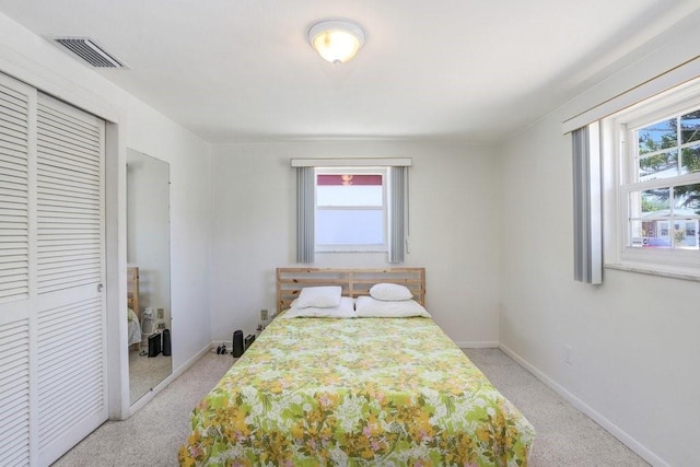 3247 Kimberly Oaks Dr, Holiday, FL 34691 - bedroom with multiple windows, a closet, and carpet floors