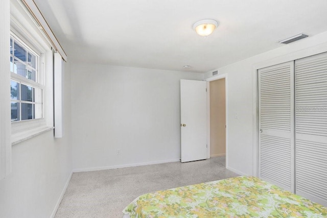 3247 Kimberly Oaks Dr, Holiday, FL 34691 - unfurnished bedroom featuring baseboards, carpet flooring, and a closet