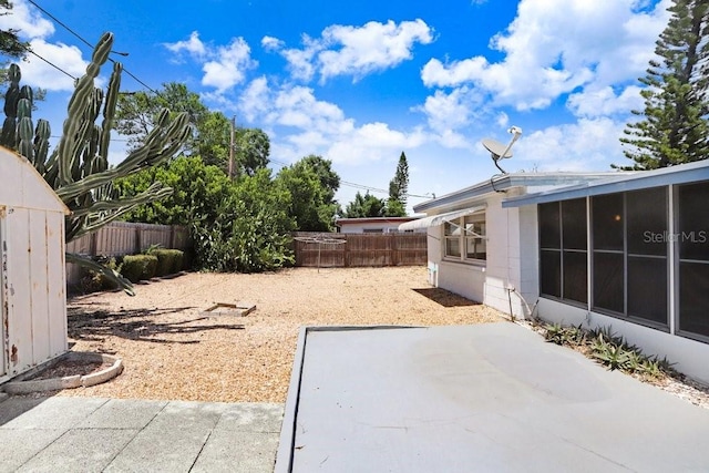 3247 Kimberly Oaks Dr, Holiday, FL 34691 - fenced backyard with a patio area and a sunroom