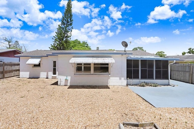 3247 Kimberly Oaks Dr, Holiday, FL 34691 - rear view of property featuring a sunroom, a patio, concrete block siding, and roof with shingles