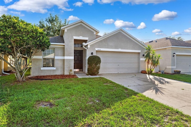 ranch-style house featuring stucco siding, a garage, driveway, and a front yard