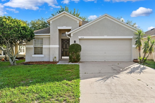 view of front of house with stucco siding, a garage, a front yard, and driveway