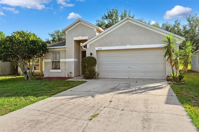 view of front facade with stucco siding, an attached garage, concrete driveway, and a front yard
