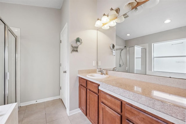 bathroom featuring a stall shower, vanity, tile patterned floors, and baseboards