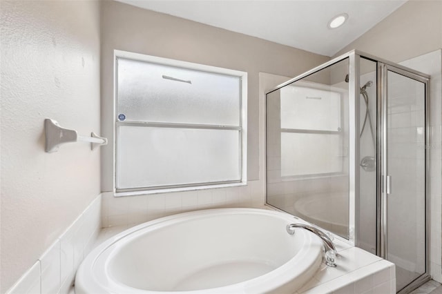 bathroom with a bath and a shower stall