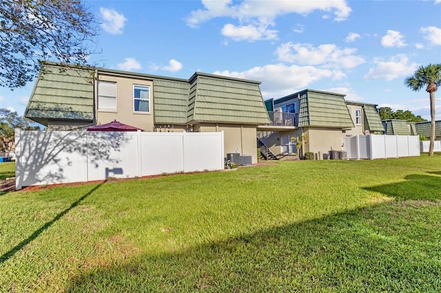 1799 N Highland Ave Unit 180, Clearwater, FL 33755 - back of property featuring mansard roof, stucco siding, and central AC