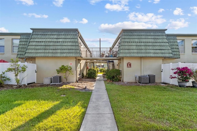 1799 N Highland Ave Unit 180, Clearwater, FL 33755 - view of property exterior with mansard roof, stucco siding, stairway, and a carport