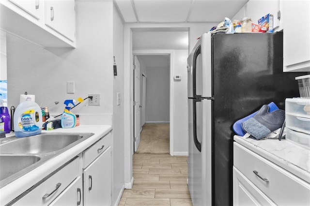 1799 N Highland Ave Unit 180, Clearwater, FL 33755 - kitchen featuring freestanding refrigerator, light countertops, and white cabinetry