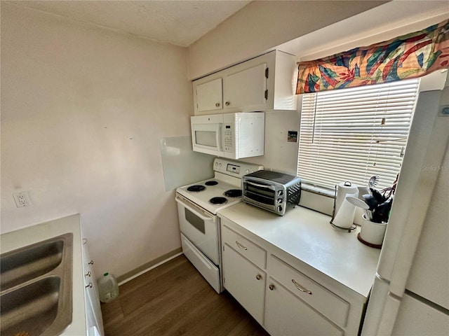 320 Medallion Blvd Unit G, Madeira Beach, FL 33708 - kitchen with white appliances, a sink, dark wood finished floors, light countertops, and white cabinetry
