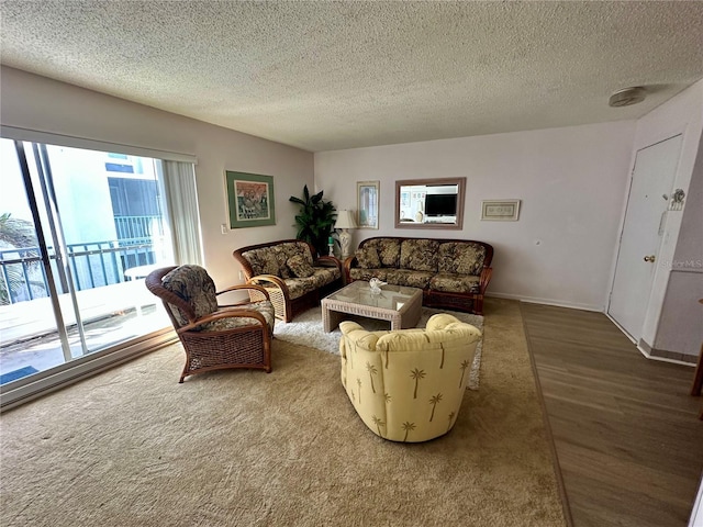 320 Medallion Blvd Unit G, Madeira Beach, FL 33708 - living room with a textured ceiling, wood finished floors, and baseboards