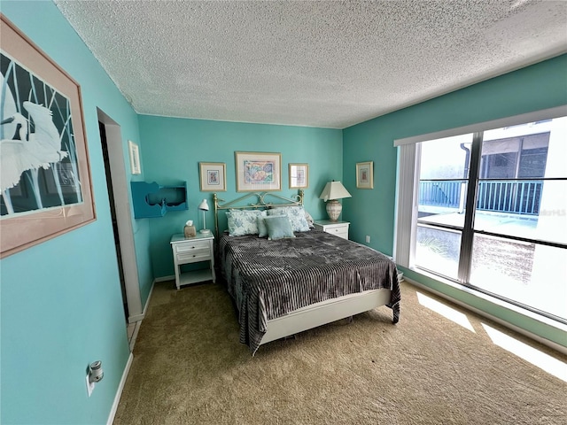 320 Medallion Blvd Unit G, Madeira Beach, FL 33708 - carpeted bedroom featuring a textured ceiling and baseboards